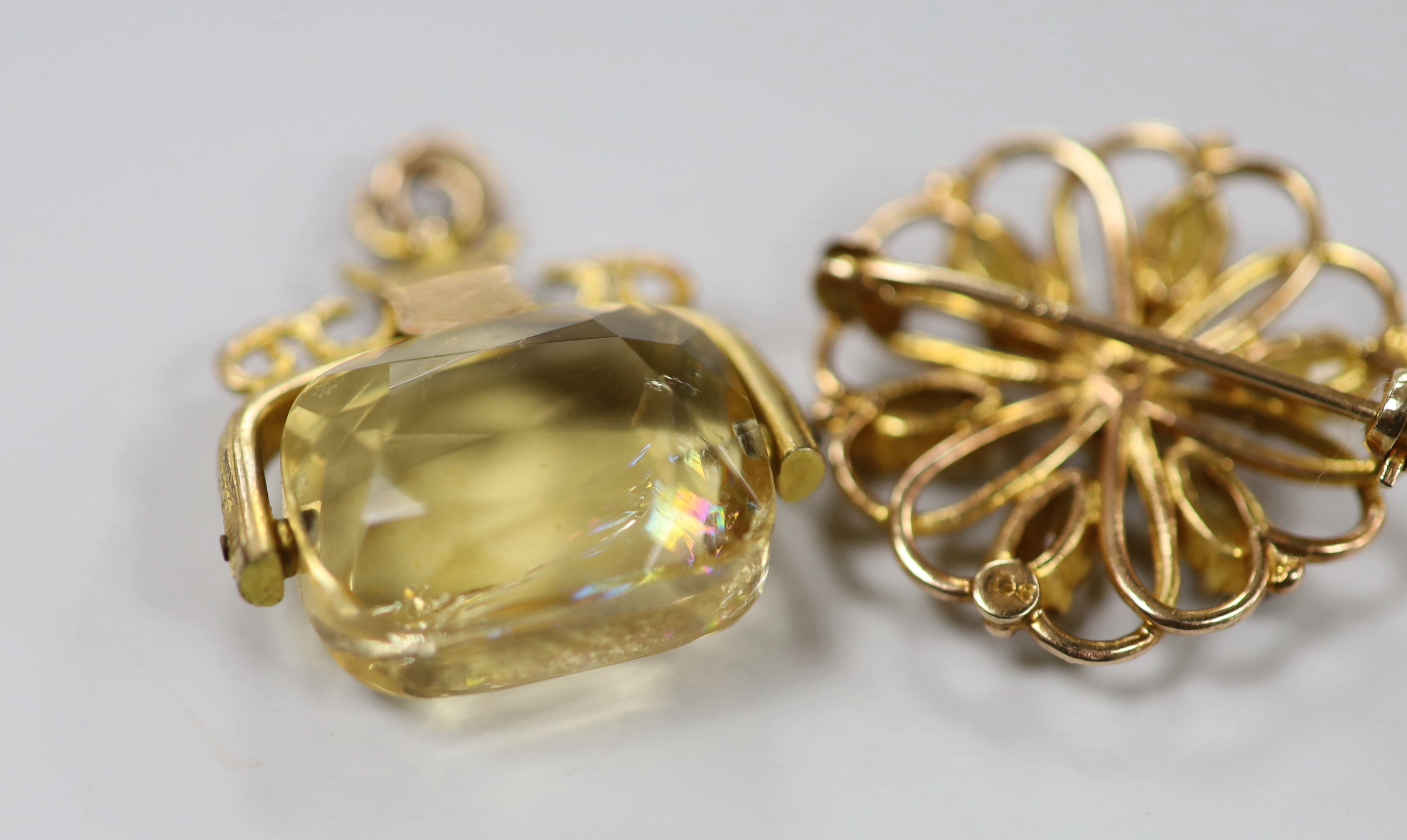 A George V 9ct gold mounted citrine spinning fob pendant, 26mm and a 9ct, citrine and cultured pearl cluster set brooch, gross weight 11.9 grams.